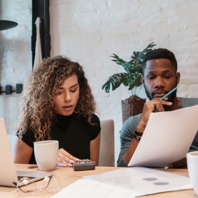 Business owners budgeting their finances to make revisions for