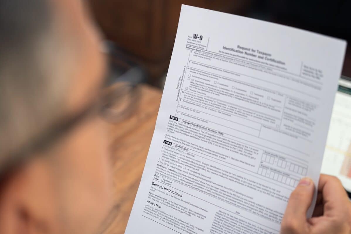 Business owner reviewing a W-9 Request for Taxpayer Identification Number form before paying a subcontractor